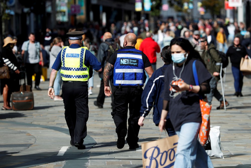 A street ranger and a police community support officer patrol Northumberland Street amid the spread of the coronavirus disease (COVID-19), in Newcastle, Britain, September 18, 2020. REUTERS/Lee Smith